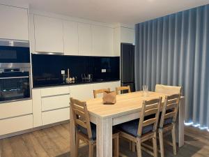 a kitchen with a wooden table and chairs at Casas da Veiga in Braga