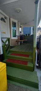 a front porch with green steps and a white door at Cozy, spacious and peaceful in Providence