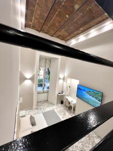 a view of a living room with a table and a television at MILUAR Luxury B&B - Vanvitelli in Naples