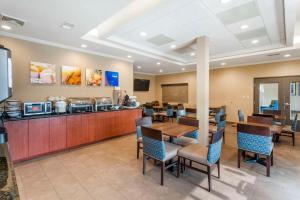 um restaurante com mesa e cadeiras e um balcão em Comfort Inn & Suites em Blytheville