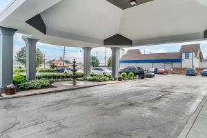 a parking lot in front of a dealership at Quality Inn & Suites Banquet Center in Livonia