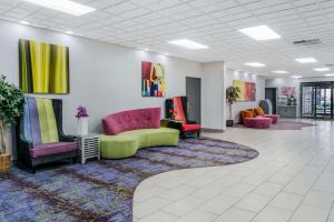 a lobby with couches and chairs on a rug at Quality Inn & Suites Banquet Center in Livonia