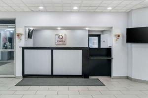 a front door of a office with a sign on the wall at Quality Inn & Suites Banquet Center in Livonia
