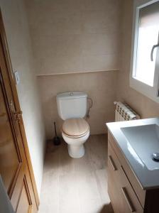 ein kleines Badezimmer mit Toilette und Waschbecken in der Unterkunft Vivienda Vacacional Alba Marinas in Pravia