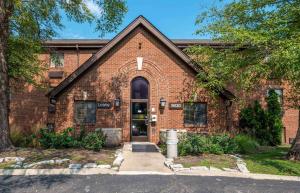 a brick building with a door in front of it at Extended Stay America Suites - Indianapolis - Northwest - College Park in Indianapolis