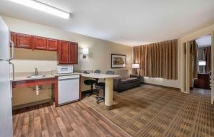 a hotel room with a kitchen and a living room at Extended Stay America Suites - Indianapolis - Northwest - I-465 in Indianapolis