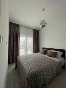 a bedroom with a large bed and a window at Wistaria Hill in Ðenovići
