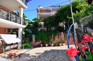 un patio de una casa con plantas y flores en Villa Ektoras by EY Villas en Parga