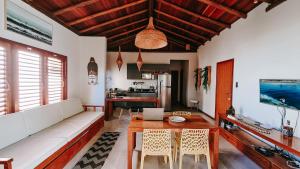 a living room with a couch and a table at Barra Grande Bangalôs in Marau