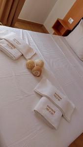 a bed with white towels and rolls on it at Villa Pedja Zec Exclusive 3+ in Budva