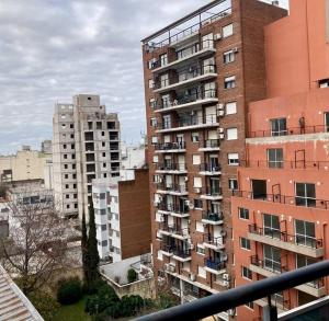 a tall building with balconies in a city at 5-Súper Dpto en Morón centro in Morón