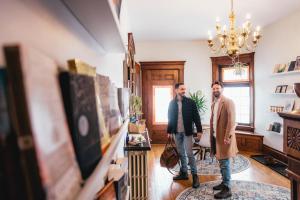 two men are standing in a living room at HoriZen Bnb in Leamington