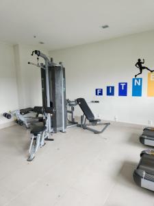 a gym with treadmills and chairs in a room at Via Premiere Suite 710B in Rio de Janeiro