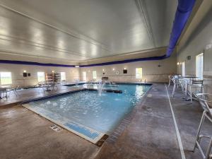 a large swimming pool in a large room at Highland Suites Extended Stay in Minot