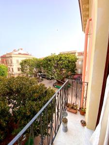 a balcony of a building with a view of a courtyard at Guest House Baruffi in Carloforte