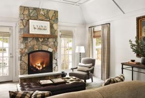 a living room with a fireplace and a couch at The White Barn Inn & Spa, Auberge Resorts Collection in Kennebunk