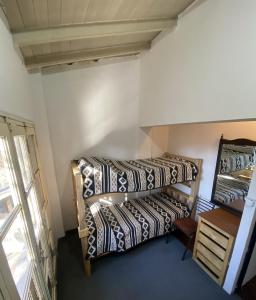 two bunk beds in a room with a window at Casa de papel in Mendoza