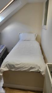 a bed in a small room with a white mattress at Memory Homes MM H2 in Dukinfield