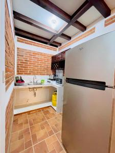 a kitchen with a refrigerator and a sink at Villa Bonita Los Naranjos in Los Naranjos