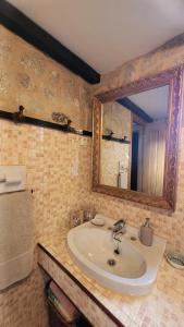 a bathroom with a sink and a mirror at La casita "A de Naval" in Pontevedra