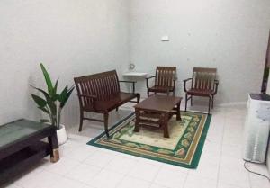 a room with three chairs and a table and a table at Homestay Kasturi Teluk Kalong Kemaman in Kijal
