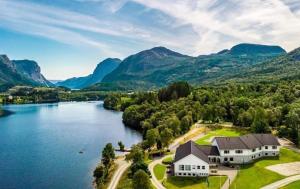an aerial view of a house on the shore of a lake at Pulpit Rock Hostel Vaulali in Tau