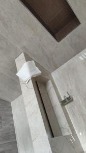 a marble bathroom with a sink and a towel at Villa piscine sans vis à vis vue mer in Tangier