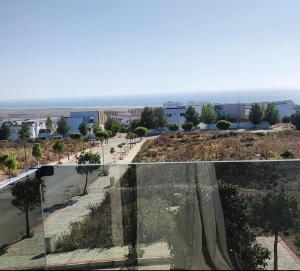 a view of a city from a glass house at Villa piscine sans vis à vis vue mer in Tangier