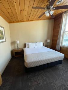 a bedroom with a bed with a ceiling fan at Hanging Horn Lakeside Resort in Moose Lake