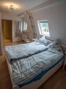 um quarto com uma cama com um edredão e uma janela em FeWo-tt em Traben-Trarbach