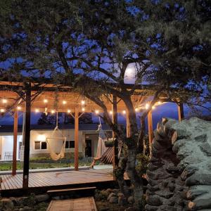 a hammock on the porch of a house at night at Cabañas San José Chotuj 