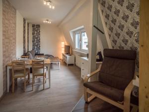 a dining room and living room with a table and chairs at FeWo-tt in Traben-Trarbach
