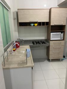 a small kitchen with a counter and a microwave at Ed Odilon Vieira 304 in Vitória da Conquista +6 photos