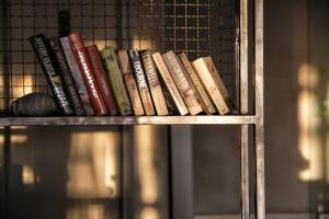 a group of books sitting on a shelf at Rigas Boutique Hotel & Spa in Afitos