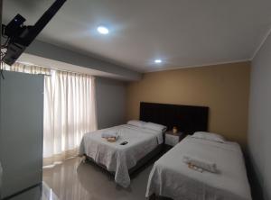 Postel nebo postele na pokoji v ubytování Inti Llaqta Hotel & Suites