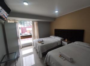 Postel nebo postele na pokoji v ubytování Inti Llaqta Hotel & Suites
