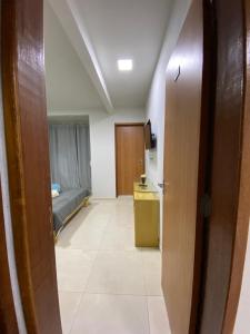 a hallway with a room with a bed and a door at Apartamento Fruto da Terra 303 in Alto Caparao