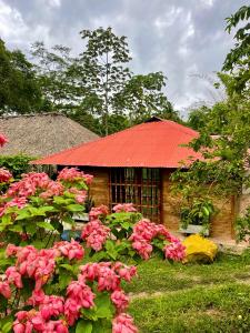 a house with a red roof and pink flowers at Finca Dos Apóstoles 