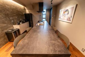 a large long table in a room with chairs at Flower Base Fuji in Muromimachi