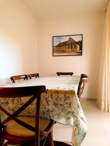 a dining room with a table and chairs at Apto novo no centro in Pomerode