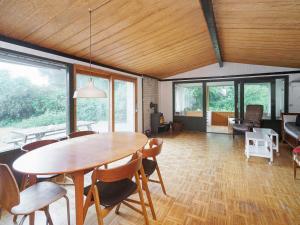 a dining room with a wooden table and chairs at Holiday home Melby IX in Melby