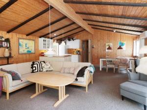 a living room with a couch and a table at 5 person holiday home in Frederiksværk-By Traum in Frederiksværk