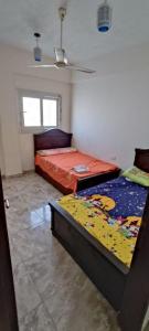 um quarto com 2 camas e um tecto em شاليه 1 ها اول علوى ٣غرف عائلات ترى البحر والبحيرة em El Alamein