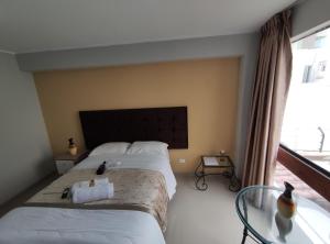 Postel nebo postele na pokoji v ubytování Inti Llaqta Hotel & Suites