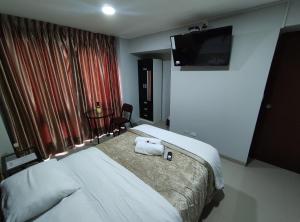 Postel nebo postele na pokoji v ubytování Inti Llaqta Hotel & Suites