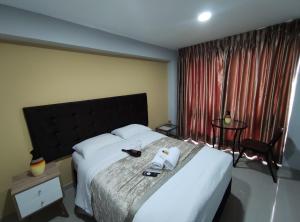 Postel nebo postele na pokoji v ubytování Inti Llaqta Hotel & Suites