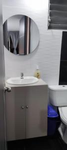 a bathroom with a sink and a mirror at La Katiritaa in Villavicencio