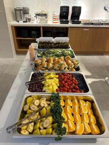 a buffet filled with different types of fruits and vegetables at Kenny Stay Busan Gijang in Busan