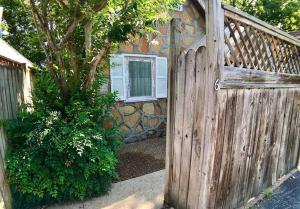 a wooden fence in front of a house at D'vinery Rock Cottage/ #6 in Eureka Springs