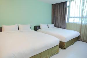 Postel nebo postele na pokoji v ubytování 823 Tourist Hotel